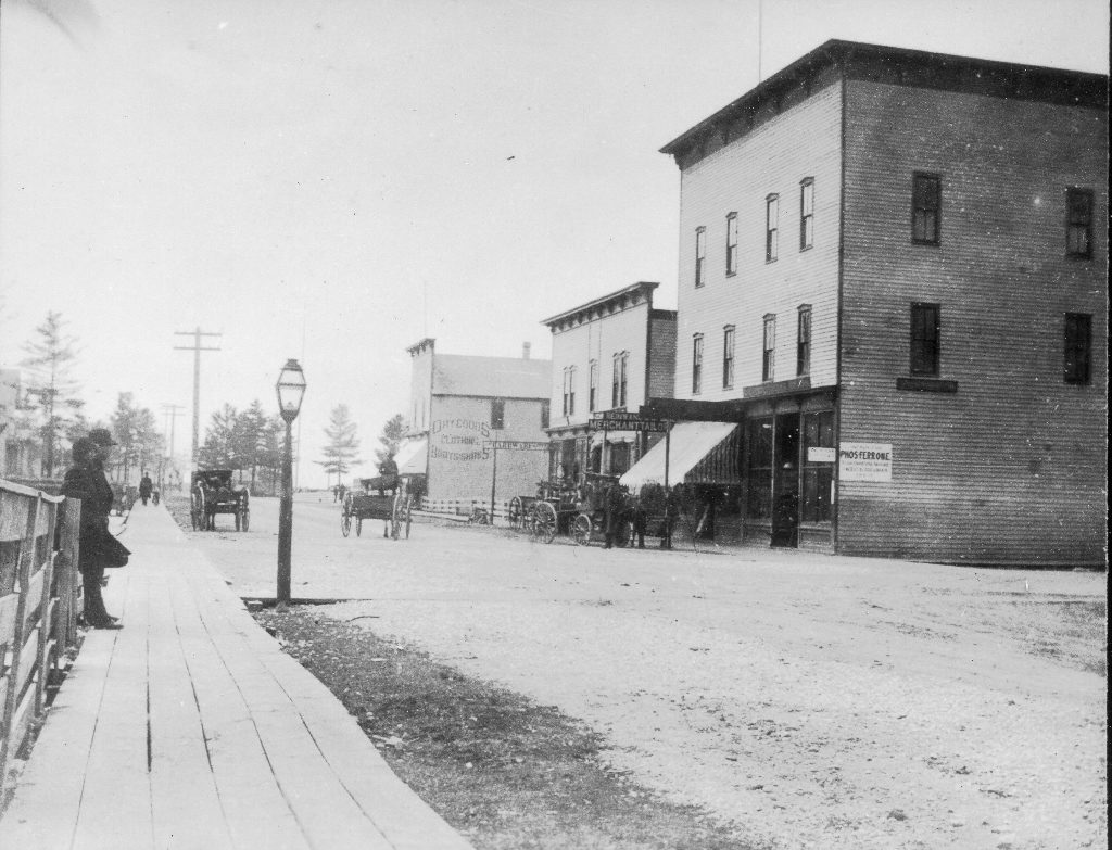 Pictured above is an 1880’s view of Cedar Street. The McKinney building (far right) housed the Thompson and Putnam Drug Store, the Winkelman dry goods store and the Currie Jewelry Store on the first floor. Other buildings on Cedar Street included Costello’s grocery and Blumrosen’s brick building.