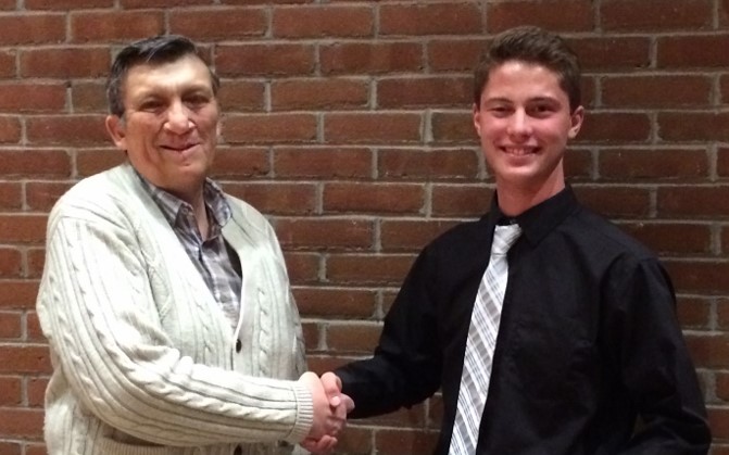 Manistique High School Senior, Logan Kraatz, is congratulated by Larry Peterson of the Schoolcraft County Historical Society. Logan won 1st place in the recent essay contest and received an award of $350. He will attend the University of Michigan in the fall.