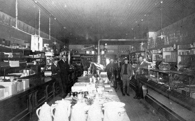 Interior of the Middlebrook Grocery located on Manistique’s Westside. The stock included a mixture of grocery, dry goods and hardware items. The shelves were lined with canned goods and signs in the rear of the store advertised “Mexoja” high grade coffee and Oleo margarine