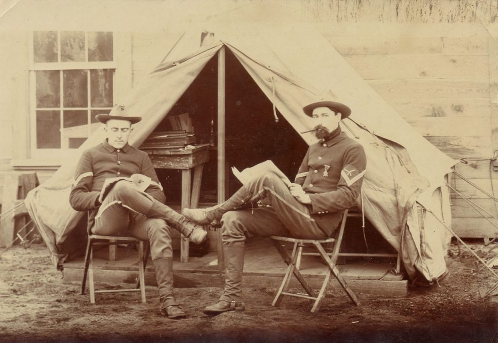 Above is a January 23, 1899 image of two officers, sitting in front of their tent at Camp Mackenzie in Augusta, Georgia. The soldier on the right is Frank Helmka. (Niles and Helmka Family Collection)